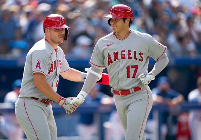 Mike Trout congratulates Shohei Ohtani after he hit a home run.